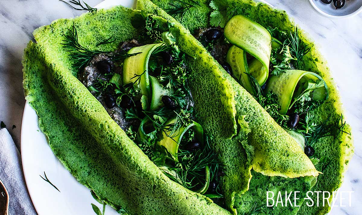 Spinach and dill crepes with black bean hummus